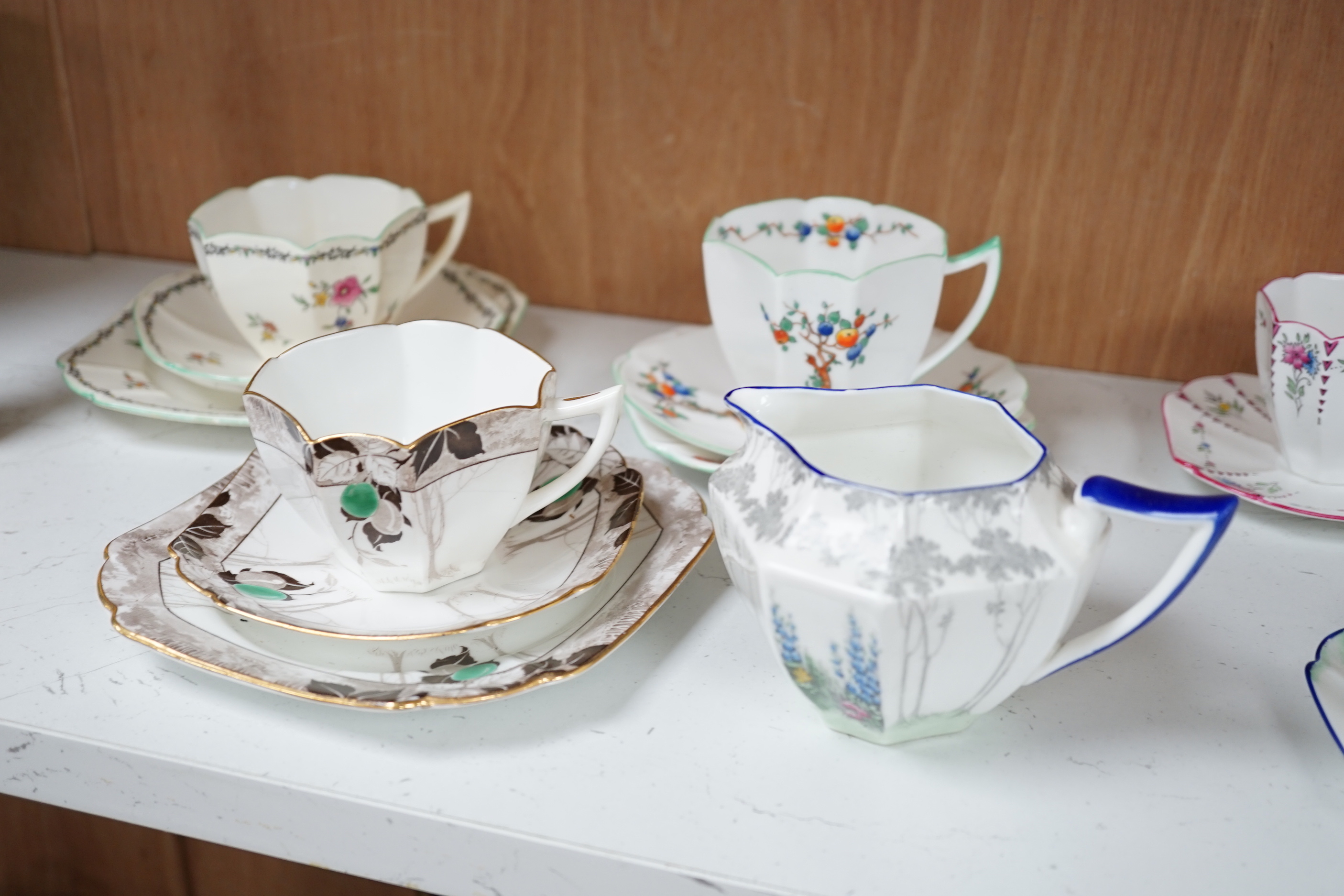 Seven Shelley Art Deco cups and saucers, three trios and a milk jug, some with Art Deco designs, largest 13cm wide